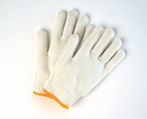 Pair of string knit work gloves for hand protection on white background